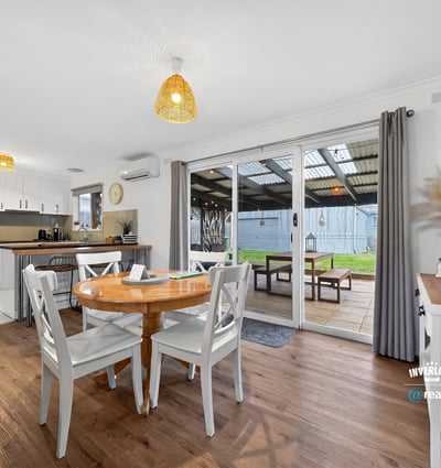 Bright dining area opening to a covered patio, perfect for indoor-outdoor living and entertaining.