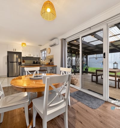 Bright, open-plan dining area seamlessly connects to an outdoor space, perfect for gatherings and relaxation.