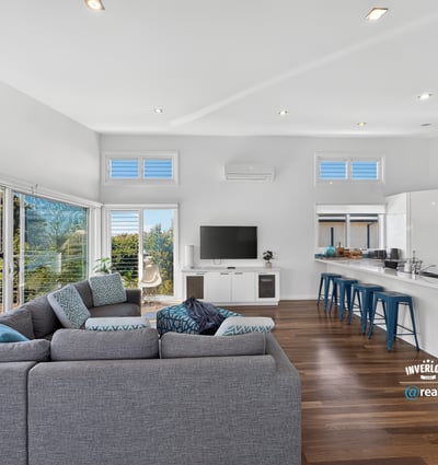 Bright, open-concept living space featuring modern design, large windows, and a seamless flow to outdoor views.