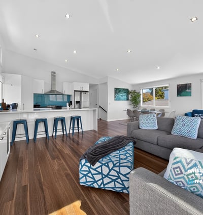 Modern open-concept living space with abundant natural light, featuring a sleek kitchen and inviting lounge area.