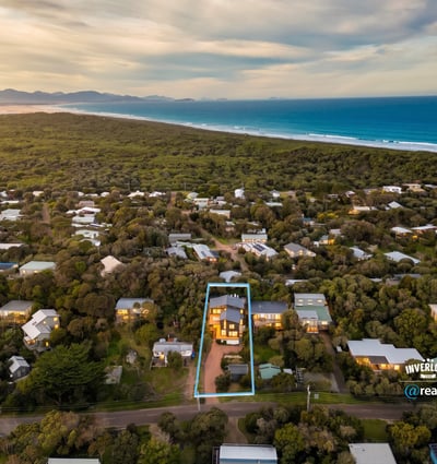 Discover a spacious home surrounded by lush landscapes, just a short stroll from beautiful coastal views.