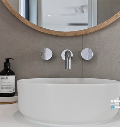 Sleek modern sink with a circular design, complemented by contemporary fixtures and minimalist decor.