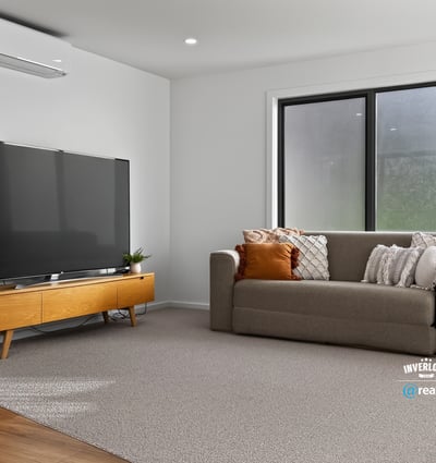 Bright and spacious living area featuring modern furnishings and large windows for ample natural light.