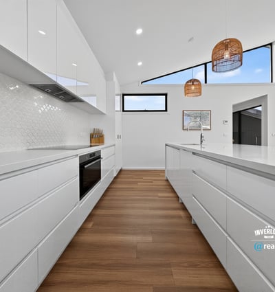 Bright and spacious kitchen featuring modern cabinetry, vast countertops, and stunning views through large windows.