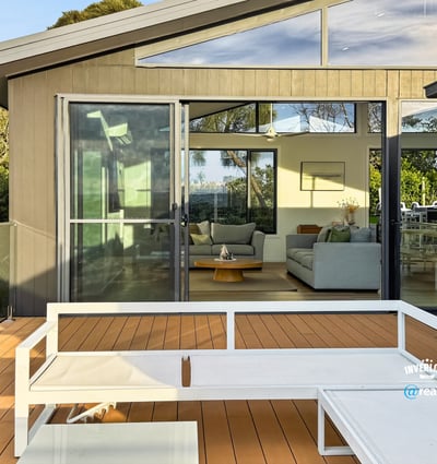 Modern home featuring a spacious deck with expansive views, seamlessly connecting indoor and outdoor living areas.