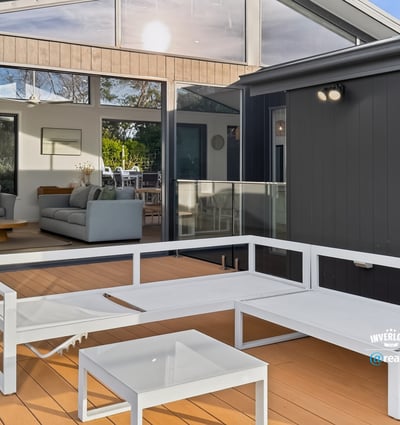 Bright outdoor living space seamlessly connects to an inviting open-plan interior, perfect for entertaining and relaxation.