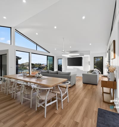 Bright, open living space features large windows, modern design, and seamless connectivity to outdoor views.