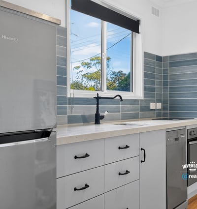 Modern kitchen featuring sleek appliances, ample storage, and natural light, perfect for culinary enthusiasts.