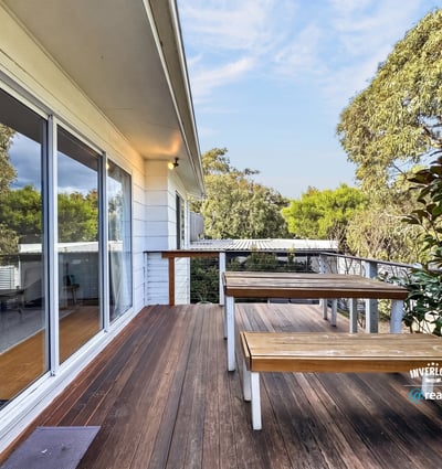 Enjoy outdoor living on this spacious deck, surrounded by lush greenery and natural beauty.