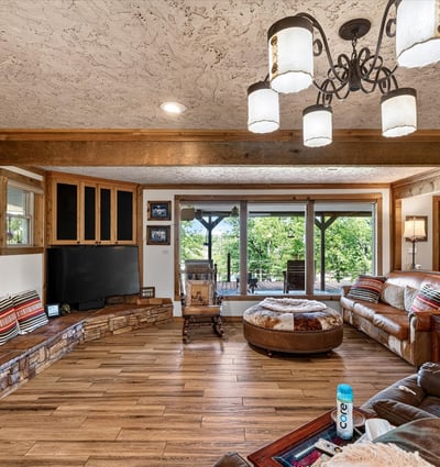 Spacious living area features a cozy layout with natural light, rich textures, and ample seating for gatherings.