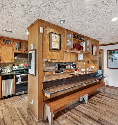 This inviting kitchen features ample cabinetry, modern appliances, and a cozy breakfast bar for casual dining.
