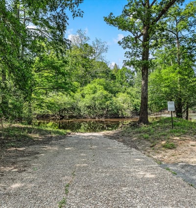 Private boat launch into Dorcheat Bayou, surrounded by lush greenery and tranquil views.