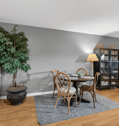 Bright and inviting living space featuring a cozy dining area and rich hardwood flooring throughout.