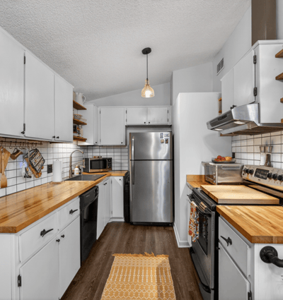 Modern kitchen featuring sleek cabinetry, butcher block countertops, and ample storage for all your culinary needs.