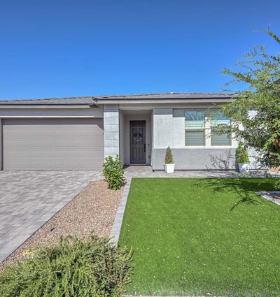 Crisp lines, designer stone accents, and easy-care desert landscaping define this newer construction Peoria home s refined curb appeal.