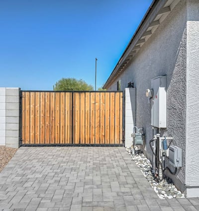 This custom RV gate provides secure and convenient side-yard access for recreational vehicles or trailers. Complete with paver stone drive and clean modern fencing, it's a standout feature for flexibility and function in Peoria living.