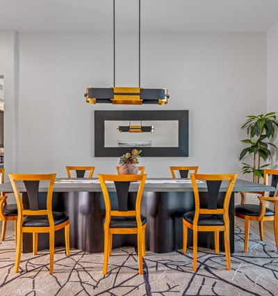 Contemporary dining room with designer lighting, seating for family gatherings, and open flow to the great room in Scottsdale.