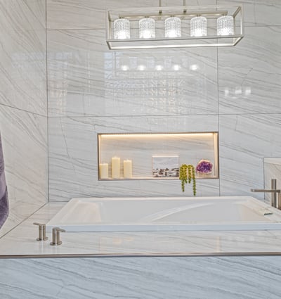 A spa-inspired soaking tub with designer tile and lighted niche creates the perfect place to unwind.