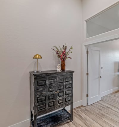 Hallway access connects the primary suite to an additional bedroom or office, offering versatile living space.