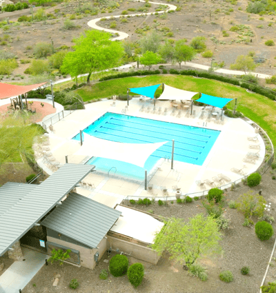 Swim year-round in the heated pool with lap lanes, shaded pergolas, and ample seating an ideal gathering spot within Vistancia.