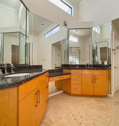 Stylish double vanity with granite countertops, large mirrors, and updated fixtures. Designed for both beauty and practicality.