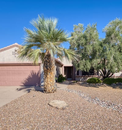 Featuring mature desert landscaping and a tiled roof, this energy-efficient home welcomes you with timeless Southwest design and exceptional curb appeal in Surprise.
