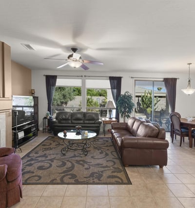 Expansive windows brighten this inviting living space, highlighting the seamless connection to the private backyard and showcasing the best of Arizona indoor-outdoor living.
