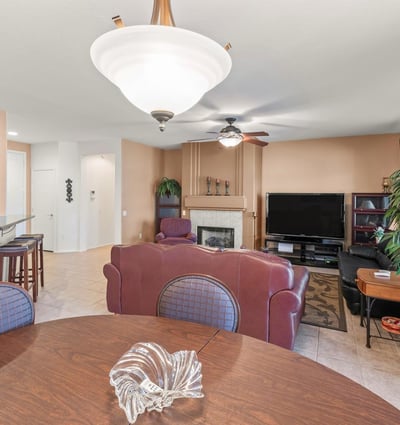 A beautiful dining area opens effortlessly to the living room and kitchen. Elegant lighting and tile floors enhance its bright, open ambiance.
