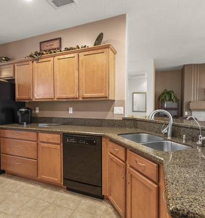 Enjoy a kitchen that blends warmth and practicality, offering expansive countertops, ample cabinets, and a seamless connection to the main living area.