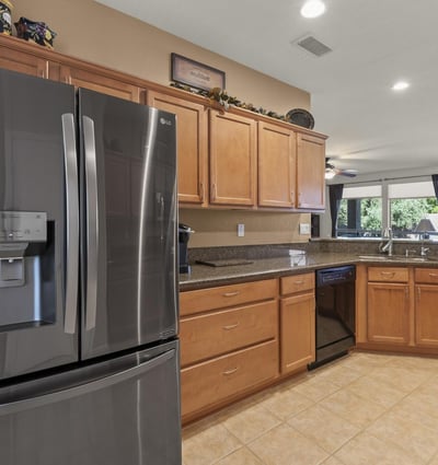 Designed for togetherness, this kitchen opens to the living room with modern finishes and a granite breakfast bar that invites casual dining.