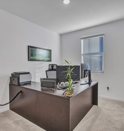 Natural light fills this front bedroom, offering a peaceful setting for guests or work. The room s clean lines and soft carpet complement the home s Litchfield Park charm.