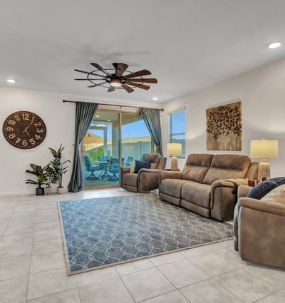 An inviting living space with natural light, tile floors, and access to the backyard. Energy-efficient design supports comfort throughout this Litchfield Park home.