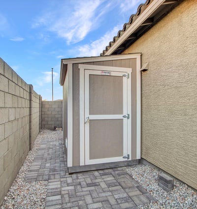 A sturdy exterior shed expands storage options, perfect for organizing tools and equipment in this Litchfield Park property.