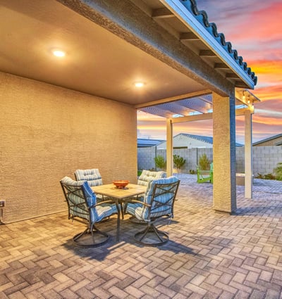 A beautifully lit covered patio highlights the home s upgraded outdoor finishes, including paver flooring and a pergola extension. A great spot for relaxing or entertaining in Litchfield Park.
