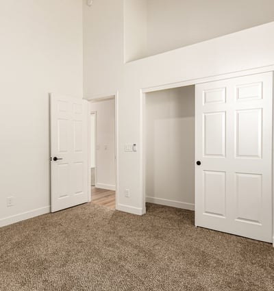 Bright guest bedroom with neutral finishes and soft carpeting. This Scottsdale room offers flexible use as a bedroom, home office, or hobby space.
