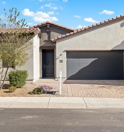Welcoming exterior presentation with desert landscaping and a paver driveway, offering low-maintenance appeal and modern style in Cave Creek.
