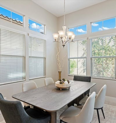 Bright formal dining space with high ceilings and elegant lighting, positioned to complement the open kitchen and living areas.