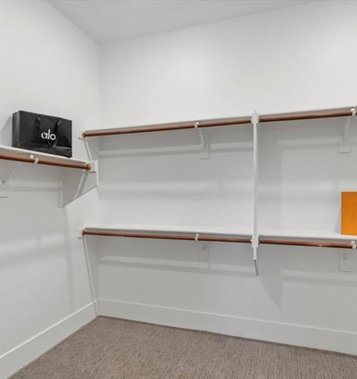 Well-designed walk-in closet with shelving and hanging areas, offering excellent storage and organization.