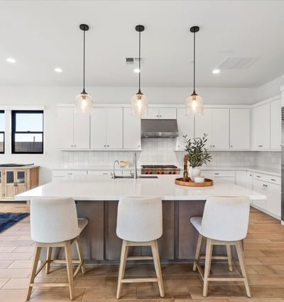 Oversized island offering seating, prep space, and storage, all wrapped in sleek modern design. A central gathering point in this Scottsdale gourmet kitchen.