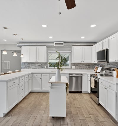 Expansive kitchen with open layout, updated cabinetry, stainless appliances, and excellent flow for entertaining in this Phoenix home.