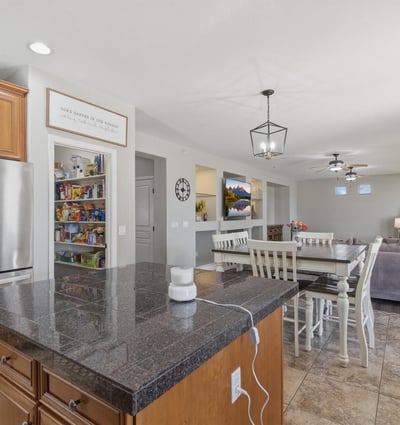 Functional kitchen featuring granite countertops, stainless steel appliances, and center island with seating, perfect for meal prep and casual dining.