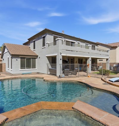 Resort-inspired backyard with freeform pool, raised spa, and spacious decking ideal for relaxing, swimming, and entertaining guests.