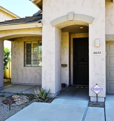 Private covered entry with elegant architectural features and shaded porch. Enhances curb appeal and welcomes guests to this Phoenix property.