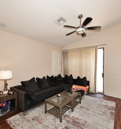 Light-filled living room with large windows and sliding door to outdoor space. This Phoenix home offers great indoor-outdoor flow.
