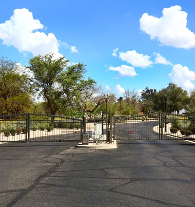 Entrance to The Fairways community featuring gated access and landscaped surroundings. This Phoenix neighborhood offers privacy and a desirable golf course setting.