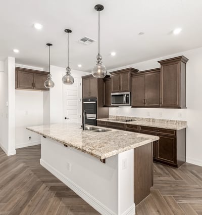 Modern kitchen with oversized island, granite counters, pendant lighting, and ample storage. Perfect blend of style and functionality.