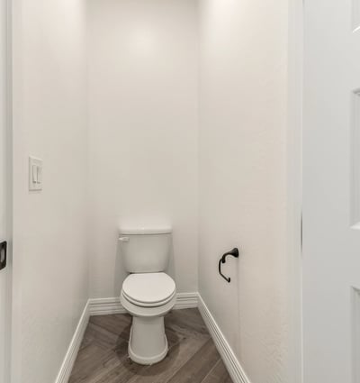 Private water closet providing additional comfort and separation within the primary bathroom.