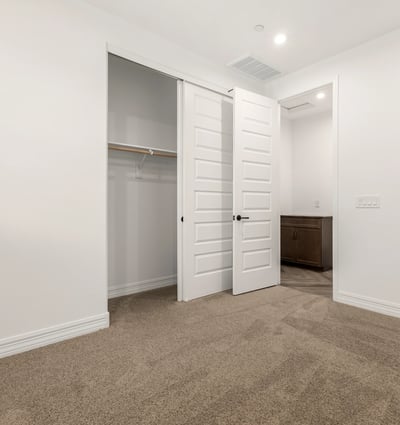 Bedroom with built-in closet and neutral design, providing flexible living space and organized storage options.