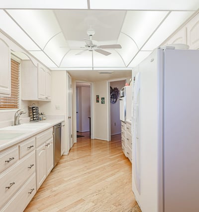 Functional kitchen with white cabinets, generous counters, and updated appliances, designed for efficient cooking and entertaining.