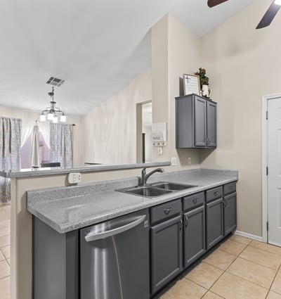 Functional kitchen featuring ample cabinetry, generous counter space, and included appliances, all open to the main living areas